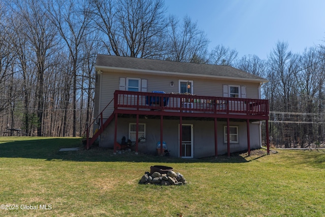 back of house featuring a wooden deck, stairway, and a lawn