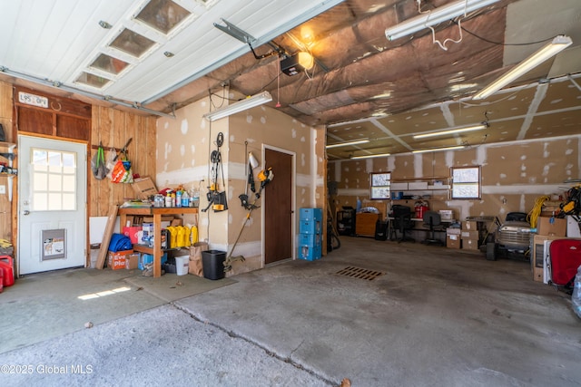 garage featuring a garage door opener and a workshop area