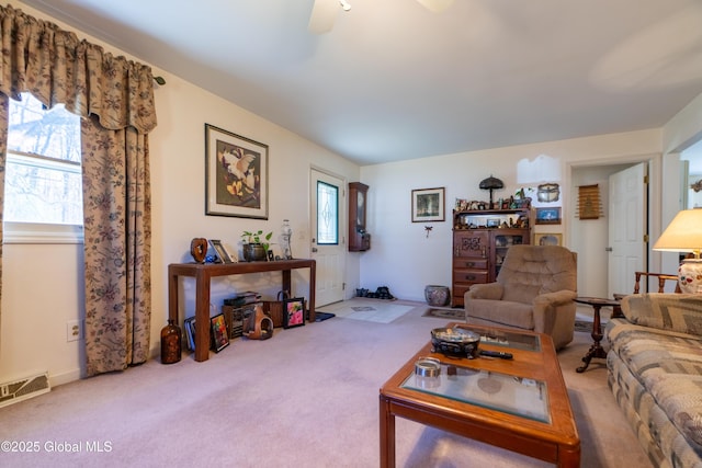 living area featuring carpet flooring, ceiling fan, and visible vents