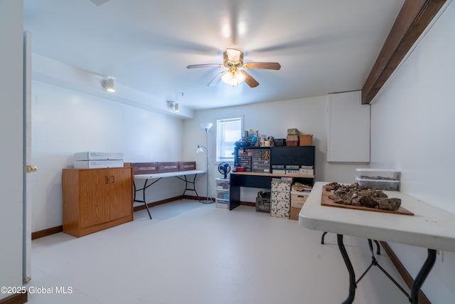 home office featuring a ceiling fan, concrete floors, and baseboards