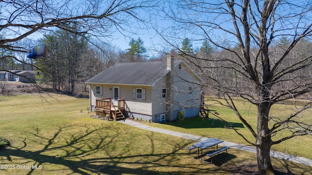 view of front of property with a front lawn, a chimney, and roof with shingles