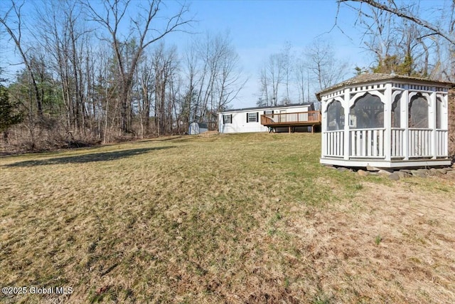 view of yard featuring a gazebo and a wooden deck