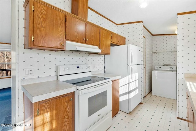 kitchen featuring crown molding, white appliances, under cabinet range hood, wallpapered walls, and washer / clothes dryer