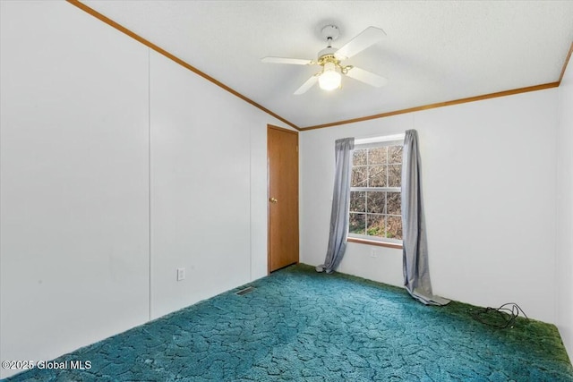 carpeted spare room with a ceiling fan, ornamental molding, and lofted ceiling