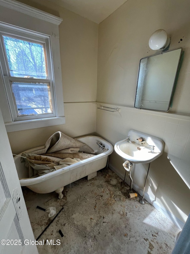 bathroom with a tub to relax in