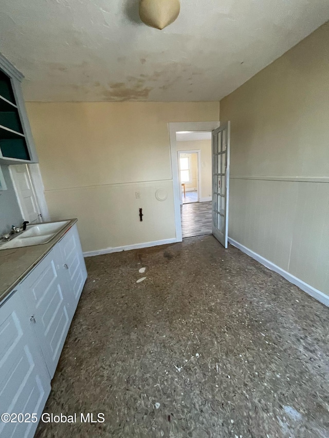 interior space featuring baseboards and wainscoting
