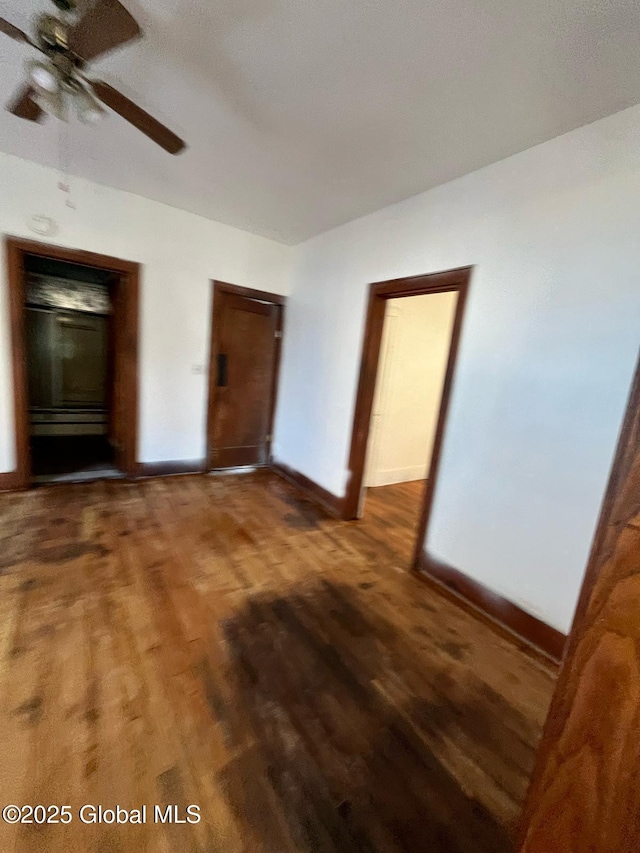 unfurnished bedroom with baseboards and wood finished floors