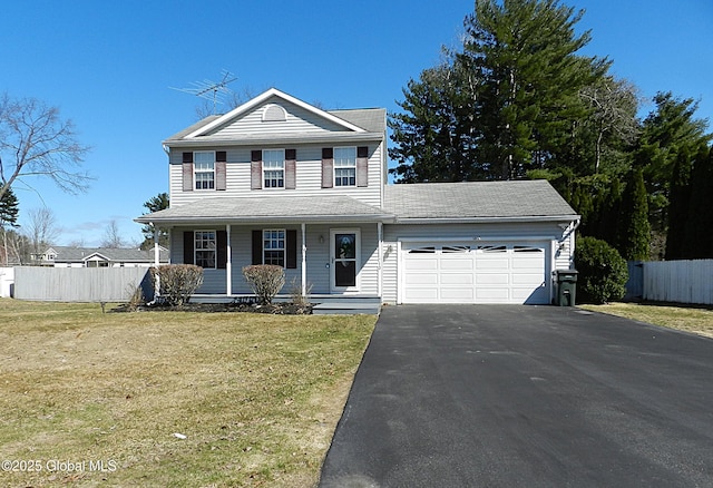 traditional home with aphalt driveway, fence, a garage, a front yard, and covered porch
