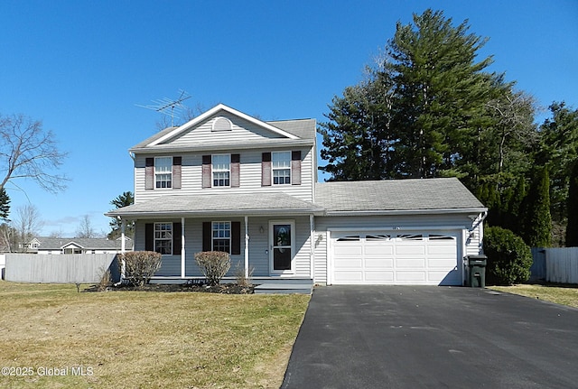traditional home with fence, driveway, a front lawn, covered porch, and a garage