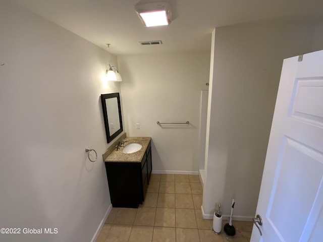 bathroom featuring baseboards, visible vents, tile patterned floors, and vanity
