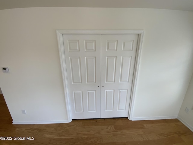 interior details with baseboards and wood finished floors