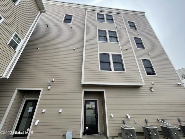 back of house with central air condition unit