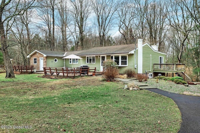 23 Leggett Rd, Ghent, NY 12075 - back of house with a chimney, a lawn, and a wooden deck