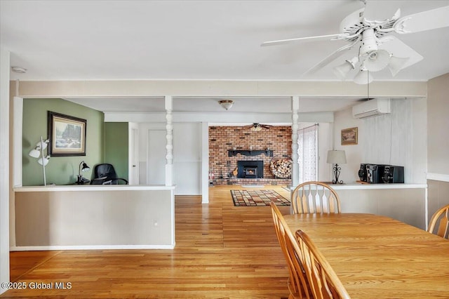 23 Leggett Rd, Ghent, NY 12075 - dining room featuring a ceiling fan, an AC wall unit, and light wood-type flooring