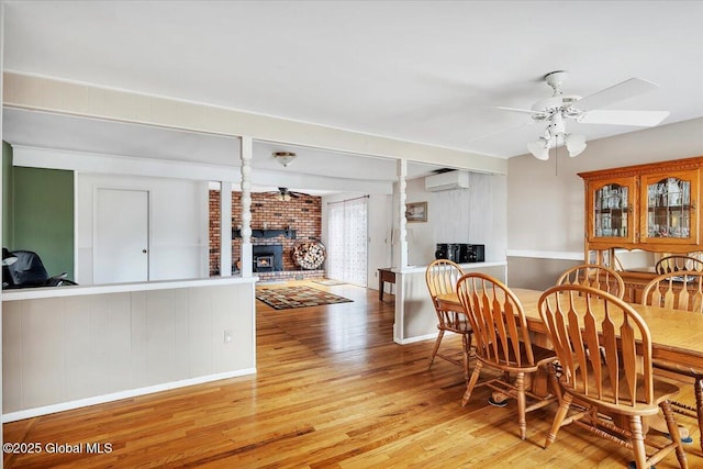 23 Leggett Rd, Ghent, NY 12075 - dining room featuring decorative columns, an AC wall unit, light wood-style floors, and ceiling fan