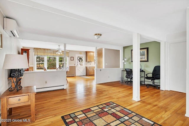 23 Leggett Rd, Ghent, NY 12075 - living area featuring a wall mounted air conditioner, light wood-style floors, baseboard heating, and a baseboard radiator