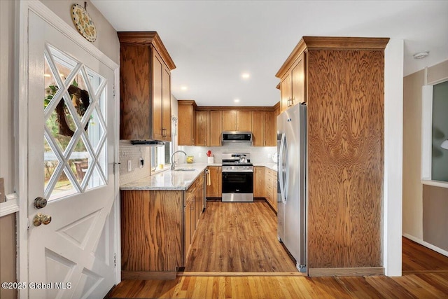23 Leggett Rd, Ghent, NY 12075 - kitchen featuring light wood-style flooring, a sink, stainless steel appliances, and decorative backsplash