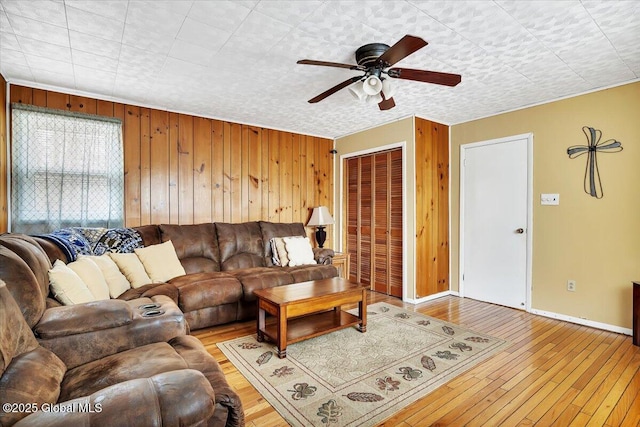 23 Leggett Rd, Ghent, NY 12075 - living area featuring baseboards, ceiling fan, wooden walls, and light wood-type flooring