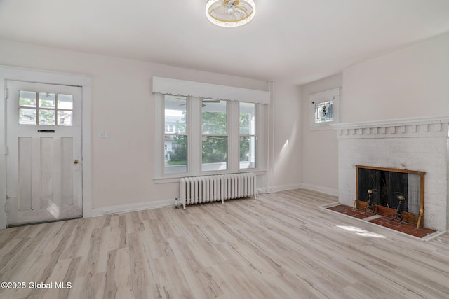 22 Fairlawn Ave, Albany, NY 12203 - unfurnished living room featuring radiator heating unit, healthy amount of natural light, wood finished floors, and baseboards