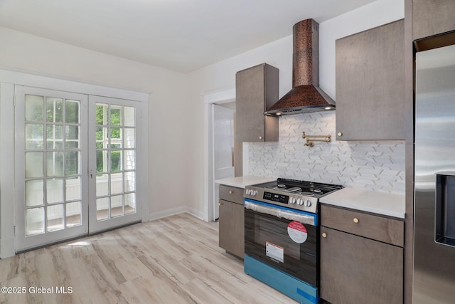 22 Fairlawn Ave, Albany, NY 12203 - kitchen featuring premium range hood, appliances with stainless steel finishes, light countertops, backsplash, and light wood-style floors