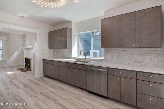 22 Fairlawn Ave, Albany, NY 12203 - kitchen featuring stainless steel dishwasher, a sink, light wood-style floors, tasteful backsplash, and light countertops