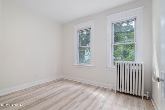 22 Fairlawn Ave, Albany, NY 12203 - empty room with radiator heating unit, light wood-style floors, and baseboards