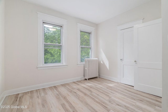 22 Fairlawn Ave, Albany, NY 12203 - unfurnished bedroom featuring radiator heating unit, light wood-type flooring, and baseboards