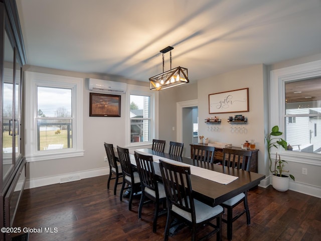 dining space featuring an AC wall unit, baseboards, dark wood-type flooring, and visible vents