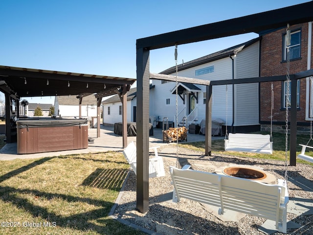 view of yard with an outdoor fire pit, entry steps, a patio area, and a hot tub