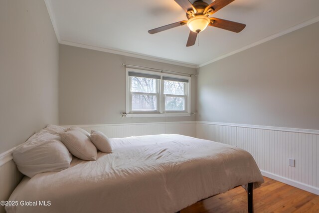 7 Bemis Heights Rd, Saratoga Springs, NY 12866 - bedroom with a ceiling fan, crown molding, wood finished floors, and wainscoting