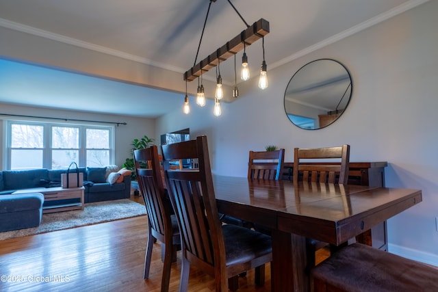 7 Bemis Heights Rd, Saratoga Springs, NY 12866 - dining space with crown molding, baseboards, and wood finished floors