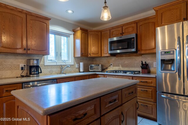 7 Bemis Heights Rd, Saratoga Springs, NY 12866 - kitchen with crown molding, brown cabinets, a sink, and stainless steel appliances