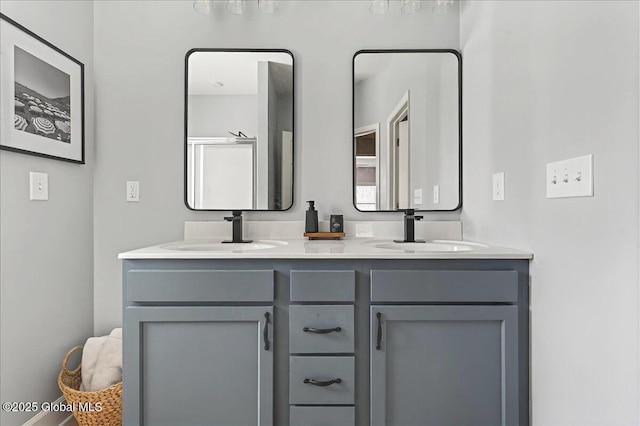 full bathroom featuring double vanity and a sink