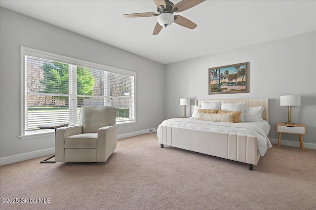 carpeted bedroom featuring baseboards and ceiling fan