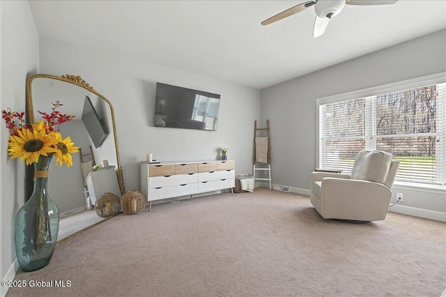 sitting room with carpet floors, baseboards, and ceiling fan