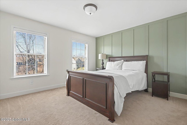 bedroom with light carpet and baseboards