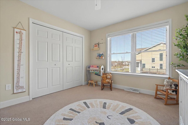 bedroom with a closet, baseboards, visible vents, and carpet floors