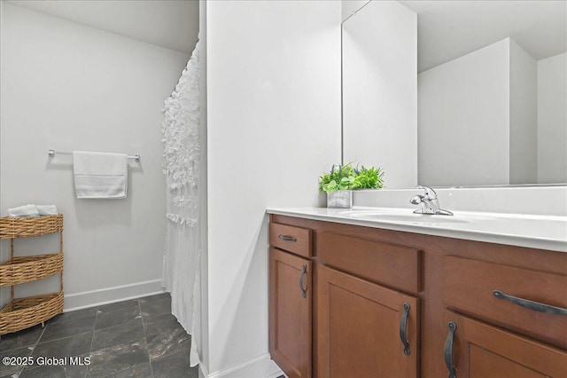 full bathroom with vanity and baseboards
