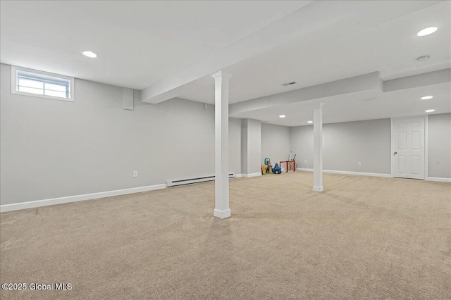 below grade area with visible vents, recessed lighting, light carpet, a baseboard heating unit, and baseboards