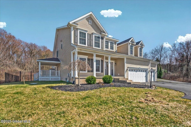 view of front of home with driveway, a front lawn, a porch, a garage, and fence