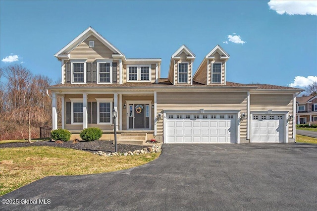view of front facade featuring an attached garage and aphalt driveway