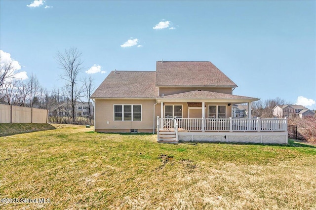 rear view of property with a yard, a deck, and fence