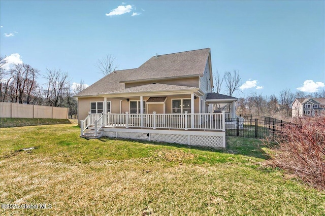 back of house with a yard, roof with shingles, and fence