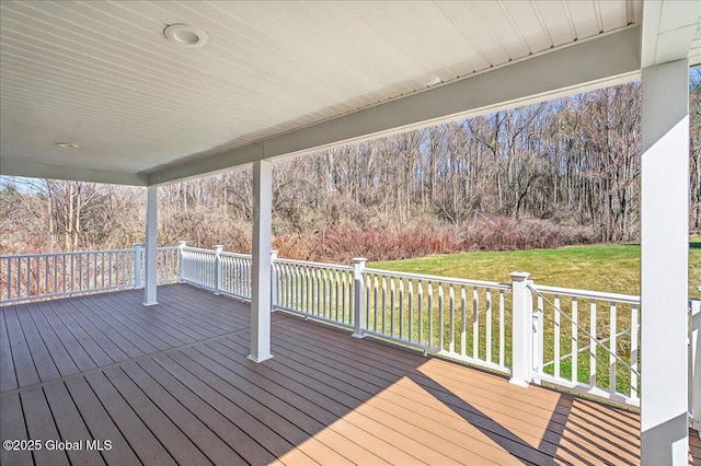 wooden terrace with a lawn