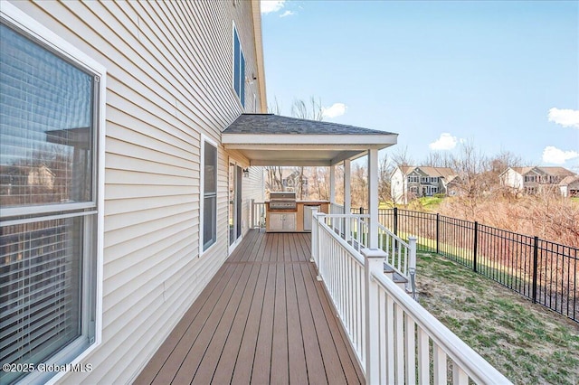 deck with a grill, a fenced backyard, and a residential view