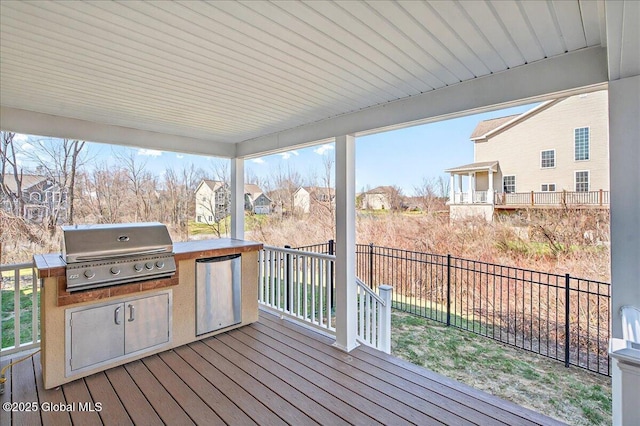 deck featuring a residential view, grilling area, fence, and area for grilling