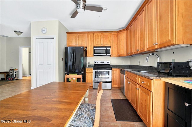 8 Wall St Apt 200, Clifton Park, NY 12065 - kitchen featuring appliances with stainless steel finishes, a sink, light tile patterned floors, and ceiling fan