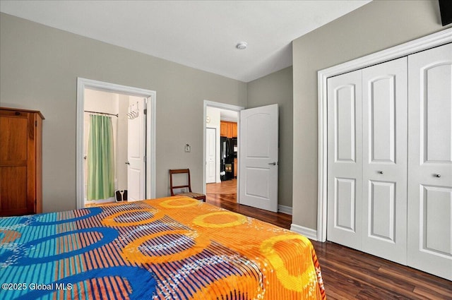 8 Wall St Apt 200, Clifton Park, NY 12065 - bedroom featuring dark wood-type flooring, a closet, freestanding refrigerator, and baseboards