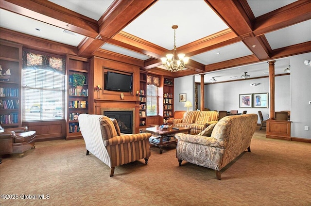 8 Wall St Apt 200, Clifton Park, NY 12065 - living room with light carpet, beamed ceiling, a chandelier, a glass covered fireplace, and ornate columns