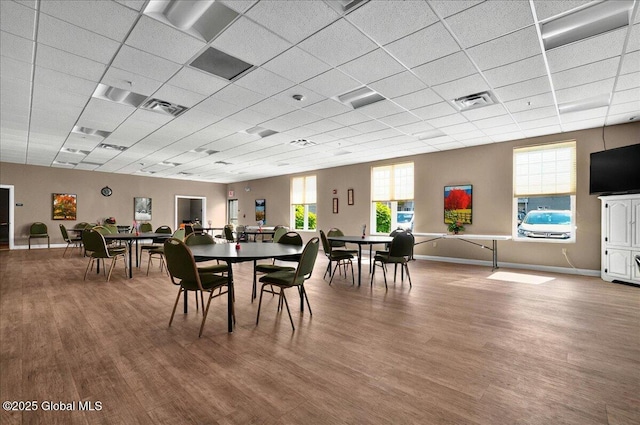 8 Wall St Apt 200, Clifton Park, NY 12065 - dining area featuring wood finished floors, a drop ceiling, healthy amount of natural light, and baseboards